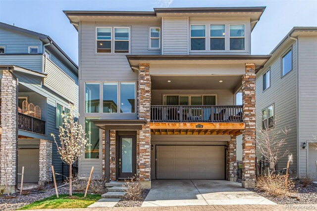 15774 W Girard Ave, Morrison, CO 80465 - view of front of property featuring concrete driveway, stone siding, and an attached garage