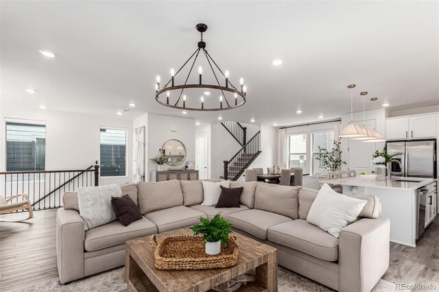 15774 W Girard Ave, Morrison, CO 80465 - living area featuring recessed lighting, light wood-style floors, and an inviting chandelier