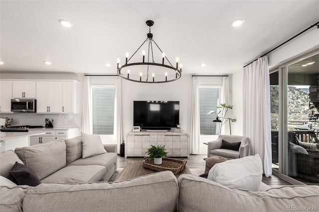 15774 W Girard Ave, Morrison, CO 80465 - living room with recessed lighting, a notable chandelier, and wood finished floors
