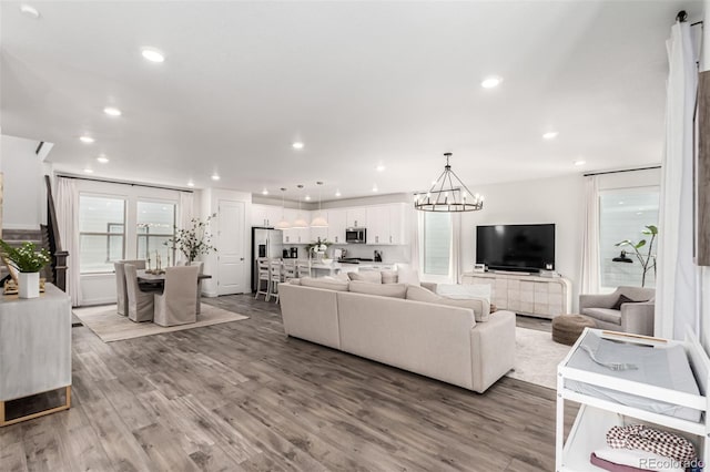 15774 W Girard Ave, Morrison, CO 80465 - living room with recessed lighting, an inviting chandelier, and wood finished floors