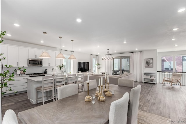 15774 W Girard Ave, Morrison, CO 80465 - dining space with a wealth of natural light, recessed lighting, dark wood-style floors, and an inviting chandelier