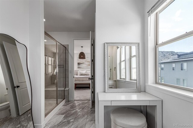 15774 W Girard Ave, Morrison, CO 80465 - bathroom featuring marble finish floor, a stall shower, and toilet