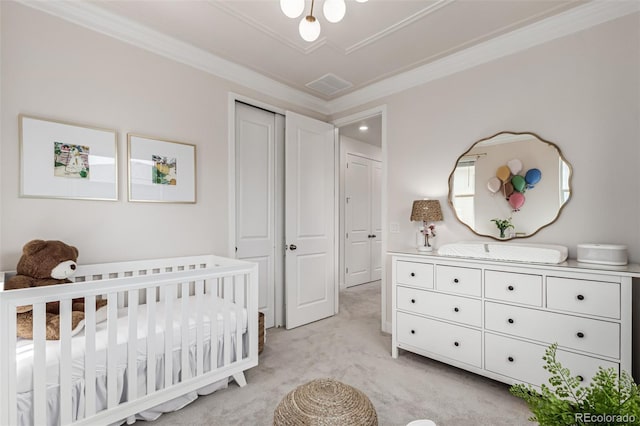 15774 W Girard Ave, Morrison, CO 80465 - bedroom with a closet, ornamental molding, a crib, visible vents, and light colored carpet