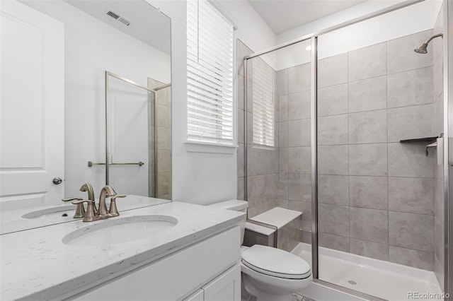 15774 W Girard Ave, Morrison, CO 80465 - bathroom featuring toilet, a stall shower, vanity, and visible vents