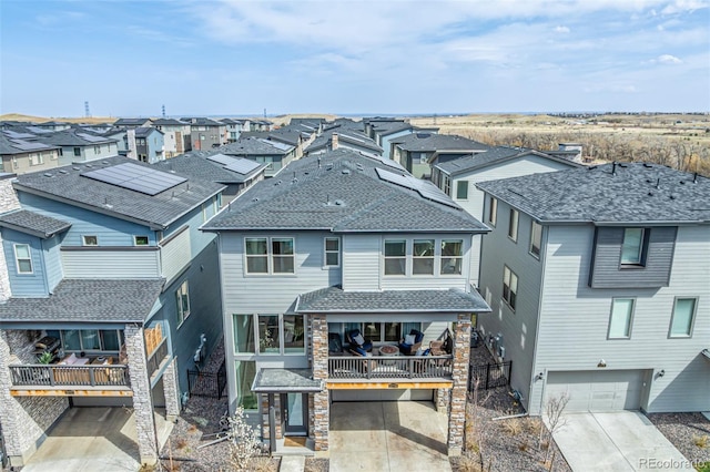 15774 W Girard Ave, Morrison, CO 80465 - exterior space featuring concrete driveway, a shingled roof, a garage, and a residential view