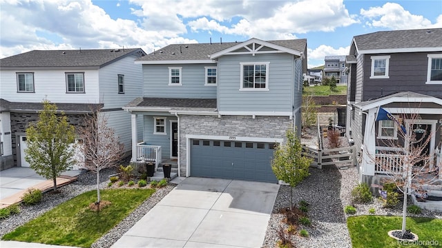 1933 Villageview Ln, Castle Rock, CO 80104 - view of front of property featuring driveway, an attached garage, stone siding, a residential view, and a shingled roof