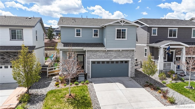 1933 Villageview Ln, Castle Rock, CO 80104 - view of front of house with concrete driveway, a garage, a residential view, a shingled roof, and stone siding