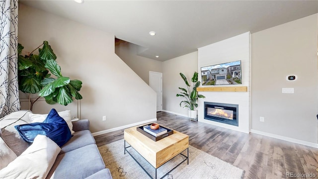 1933 Villageview Ln, Castle Rock, CO 80104 - living room featuring wood finished floors, baseboards, recessed lighting, and a glass covered fireplace
