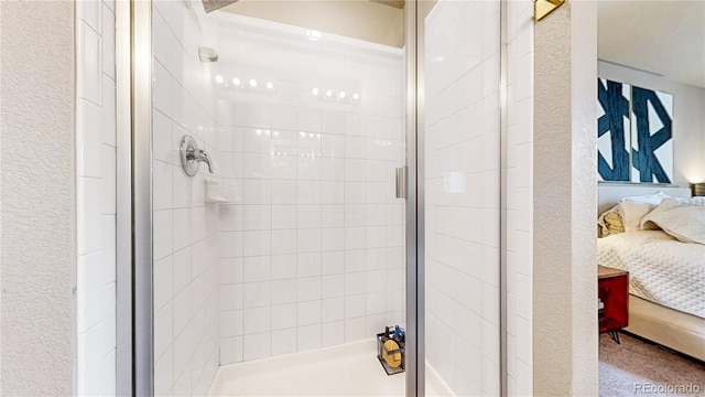 1933 Villageview Ln, Castle Rock, CO 80104 - bathroom featuring ensuite bathroom, a stall shower, and a textured wall