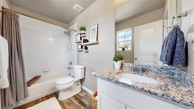 1933 Villageview Ln, Castle Rock, CO 80104 - bathroom featuring wood finished floors, baseboards, toilet, vanity, and shower / bathtub combination