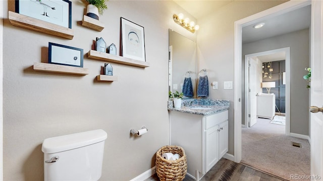 1933 Villageview Ln, Castle Rock, CO 80104 - bathroom featuring baseboards, toilet, and vanity