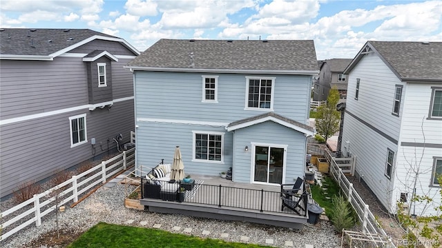 1933 Villageview Ln, Castle Rock, CO 80104 - back of property featuring a fenced backyard, a wooden deck, and a shingled roof