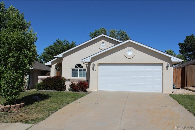 838 Edna Ln, Pueblo, CO 81005 - ranch-style home with concrete driveway, an attached garage, and stucco siding