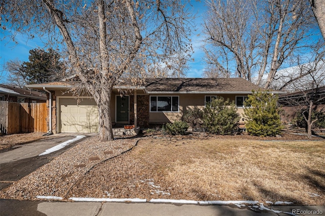 ranch-style house with a garage and a front yard