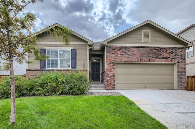 single story home featuring a garage, a front yard, concrete driveway, and brick siding