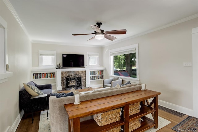 848 Harrison St, Denver, CO 80206 - living room with ornamental molding, plenty of natural light, a brick fireplace, ceiling fan, and baseboards