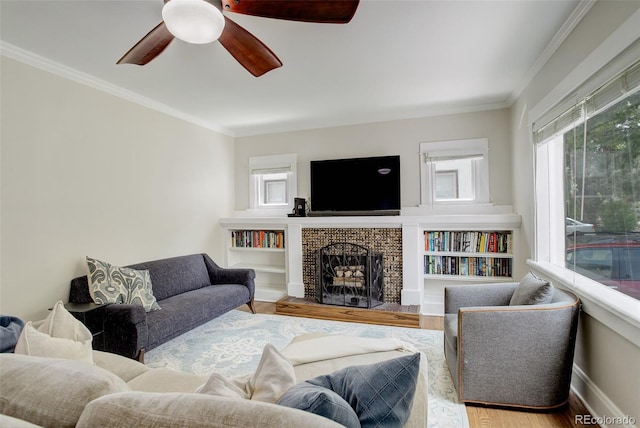 848 Harrison St, Denver, CO 80206 - living area with wood finished floors, a ceiling fan, a brick fireplace, crown molding, and baseboards