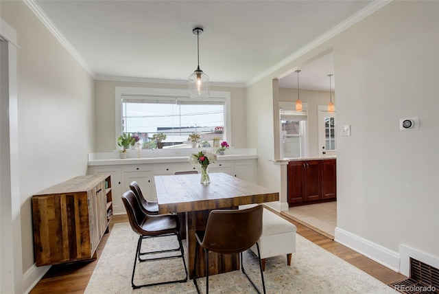 848 Harrison St, Denver, CO 80206 - dining area with ornamental molding, light wood-style floors, and baseboards