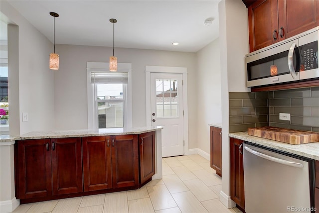 848 Harrison St, Denver, CO 80206 - kitchen featuring appliances with stainless steel finishes, reddish brown cabinets, backsplash, decorative light fixtures, and light stone countertops