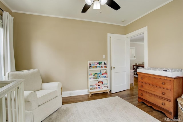 848 Harrison St, Denver, CO 80206 - bedroom featuring dark wood-style floors, crown molding, baseboards, ceiling fan, and a nursery area