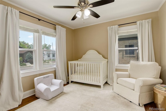 848 Harrison St, Denver, CO 80206 - bedroom featuring a nursery area, ornamental molding, baseboards, and a ceiling fan