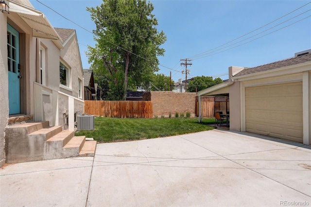 848 Harrison St, Denver, CO 80206 - view of yard with concrete driveway, central air condition unit, and a garage