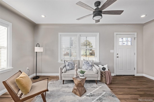 living area featuring dark wood-type flooring, recessed lighting, and baseboards