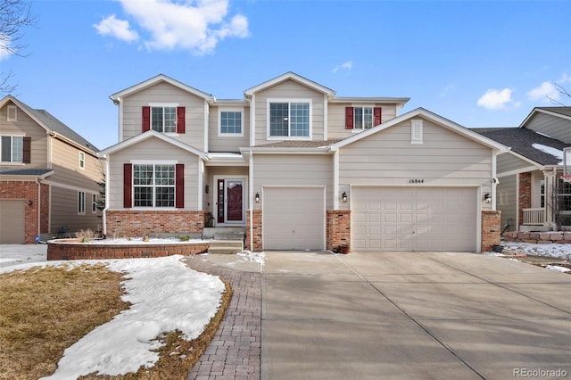 craftsman house featuring concrete driveway and brick siding