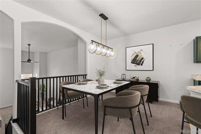 10578 E Jewell Ave, Aurora, CO 80012 - dining space featuring light colored carpet, arched walkways, and baseboards