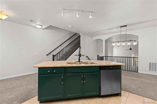 10578 E Jewell Ave, Aurora, CO 80012 - kitchen with stainless steel dishwasher, green cabinetry, light carpet, a sink, and arched walkways
