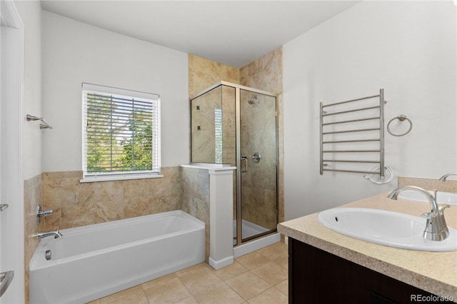 10578 E Jewell Ave, Aurora, CO 80012 - full bath with radiator, a garden tub, tile patterned floors, a shower stall, and a towel warming rack