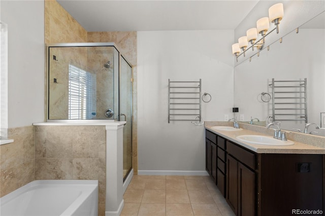 10578 E Jewell Ave, Aurora, CO 80012 - full bathroom featuring radiator, a towel warmer, a garden tub, a stall shower, and tile patterned flooring