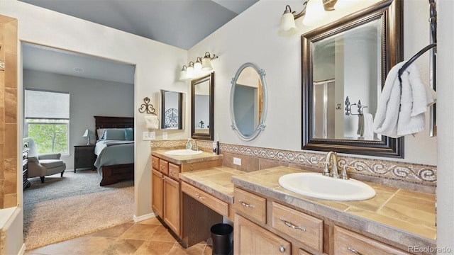 11818 Rio Secco Rd, Peyton, CO 80831 - ensuite bathroom with double vanity, a shower, tile patterned flooring, and tasteful backsplash