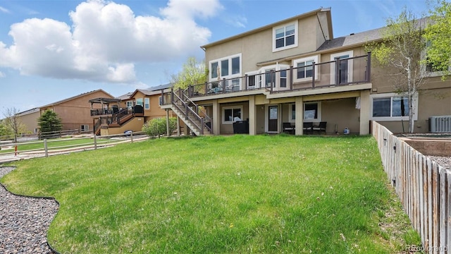 11818 Rio Secco Rd, Peyton, CO 80831 - back of house featuring stucco siding, stairs, cooling unit, and a deck