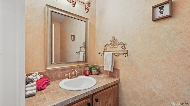 11818 Rio Secco Rd, Peyton, CO 80831 - bathroom featuring vanity and decorative backsplash