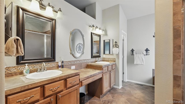 11818 Rio Secco Rd, Peyton, CO 80831 - bathroom with a shower with shower door, double vanity, and decorative backsplash