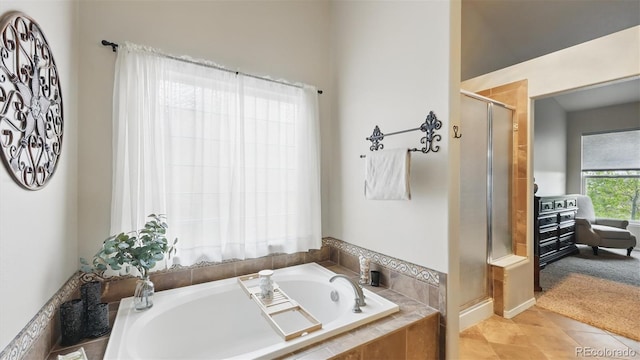 11818 Rio Secco Rd, Peyton, CO 80831 - full bathroom with a shower stall, a bath, and tile patterned flooring