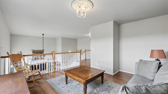 11818 Rio Secco Rd, Peyton, CO 80831 - living room with a chandelier, wood finished floors, and baseboards