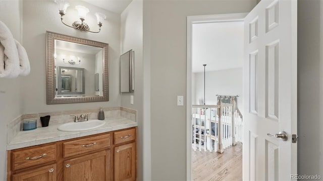 11818 Rio Secco Rd, Peyton, CO 80831 - bathroom featuring vanity, a chandelier, and wood finished floors