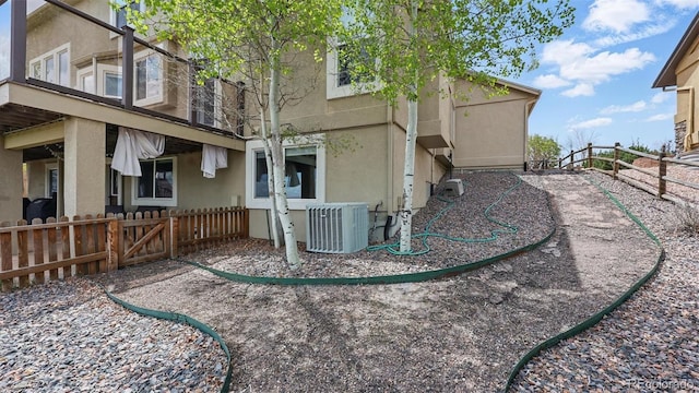 11818 Rio Secco Rd, Peyton, CO 80831 - rear view of property with cooling unit, a fenced backyard, and stucco siding