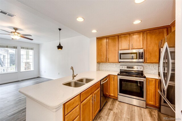 15955 E Geddes Dr Unit 55, Aurora, CO 80016 - kitchen with stainless steel appliances, a sink, light wood-style floors, light countertops, and recessed lighting