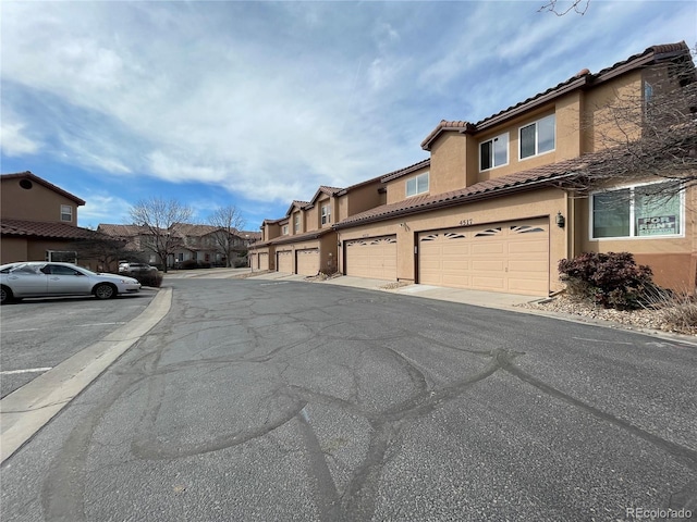 view of street with community garages and a residential view