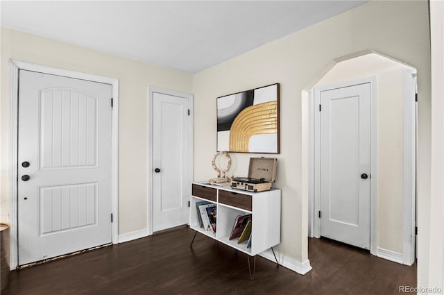 entrance foyer with dark wood finished floors and baseboards