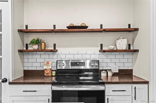 kitchen featuring tasteful backsplash, stainless steel range with electric cooktop, white cabinetry, and open shelves