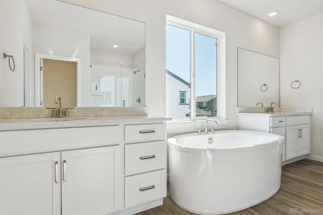 bathroom with vanity, hardwood / wood-style flooring, a healthy amount of sunlight, and separate shower and tub