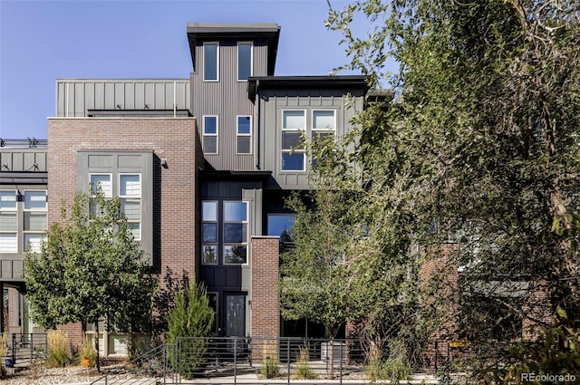 view of building exterior featuring a fenced front yard