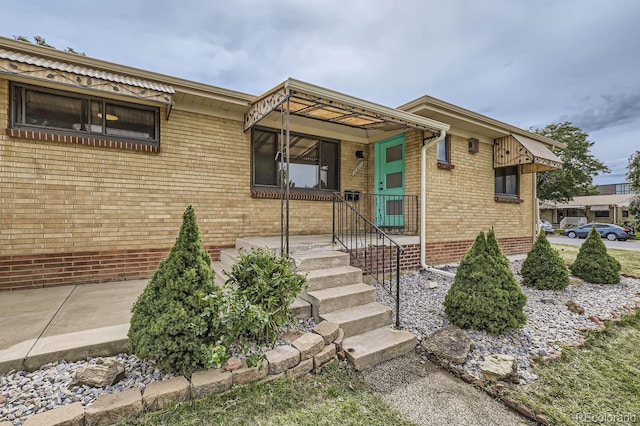 view of front of house featuring brick siding