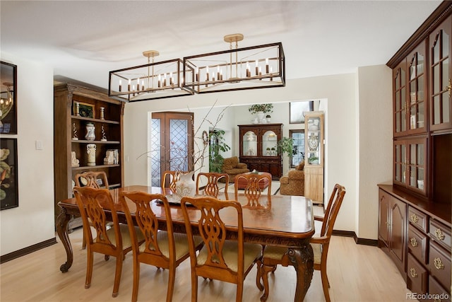 dining area with light wood-style flooring and baseboards