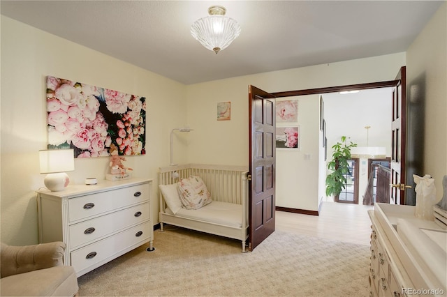 bedroom featuring light carpet and access to exterior