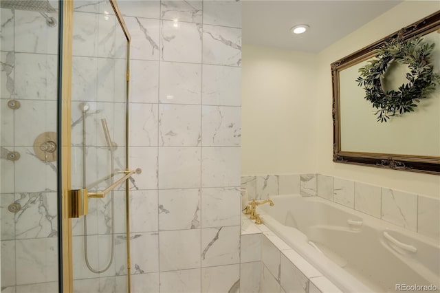 full bathroom featuring a garden tub and a shower stall